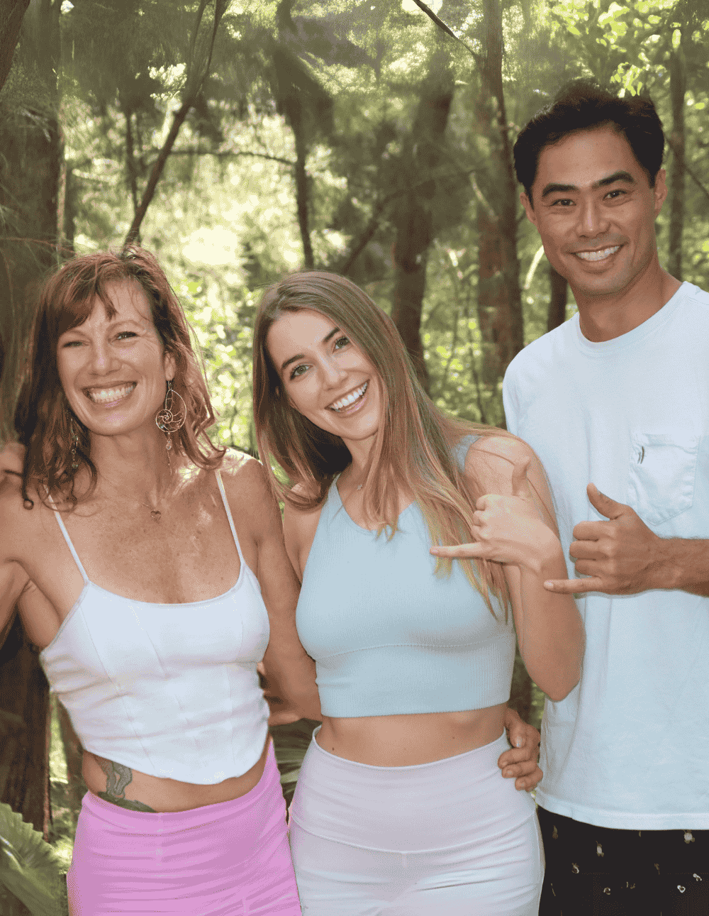 Three people smiling aloha